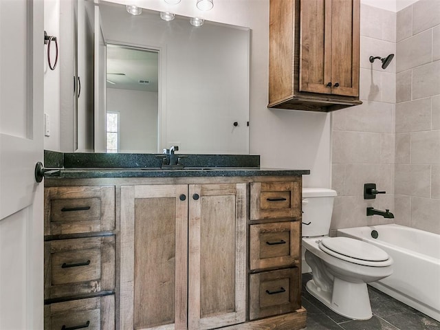 full bathroom with tile patterned floors, vanity, toilet, and tiled shower / bath combo