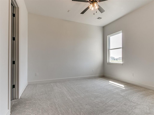 spare room with light carpet and ceiling fan