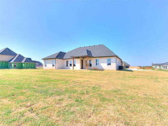 back of house with a lawn and cooling unit