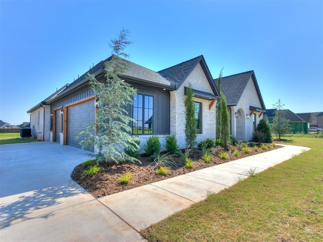 view of side of home featuring a lawn and a garage