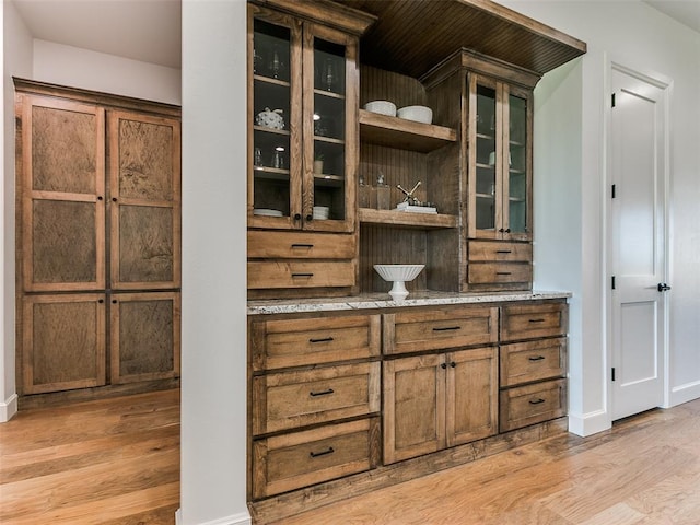 bar with light hardwood / wood-style flooring