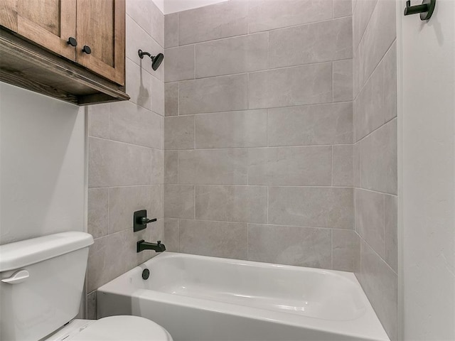 bathroom with toilet and tiled shower / bath combo