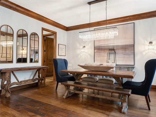 dining area featuring hardwood / wood-style flooring, ornamental molding, and an inviting chandelier