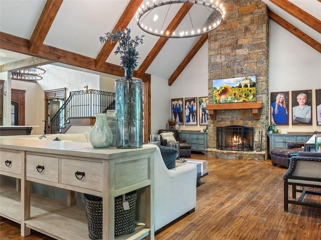 living room featuring beamed ceiling, a fireplace, and high vaulted ceiling