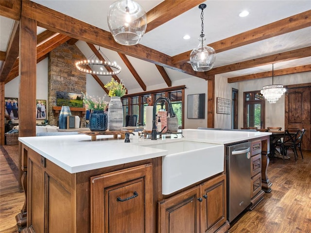 kitchen with sink, dark hardwood / wood-style flooring, lofted ceiling with beams, an island with sink, and pendant lighting