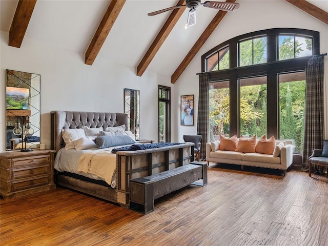 bedroom with beamed ceiling, hardwood / wood-style flooring, high vaulted ceiling, and ceiling fan