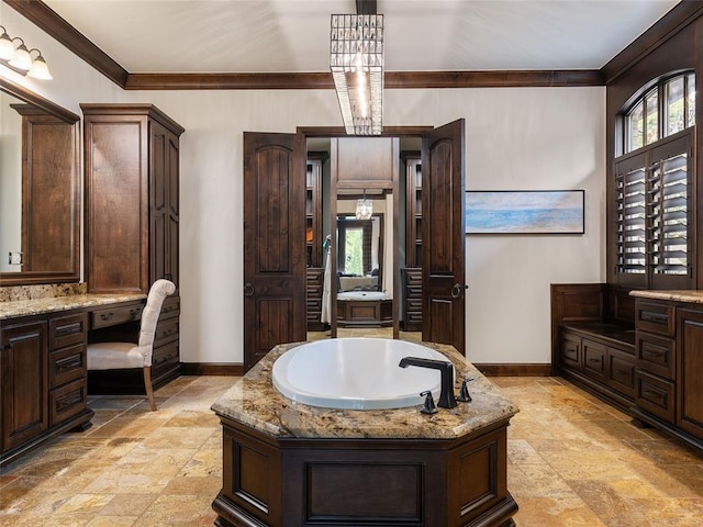 bathroom with vanity, ornamental molding, and a bath