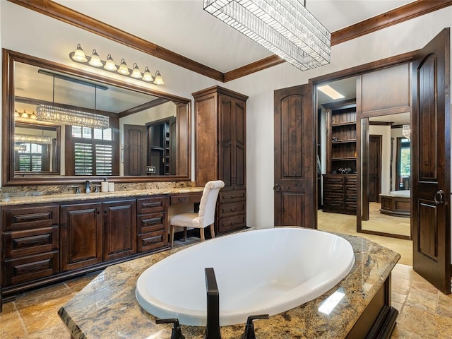 bathroom featuring vanity, crown molding, and a notable chandelier