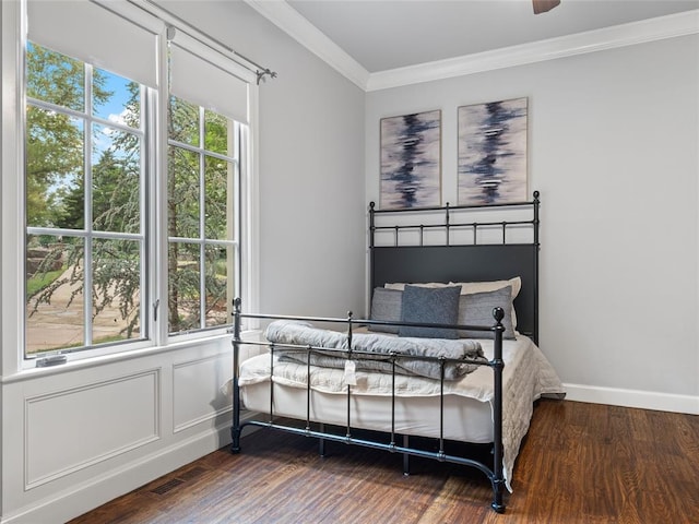 bedroom with wood-type flooring, multiple windows, ornamental molding, and ceiling fan