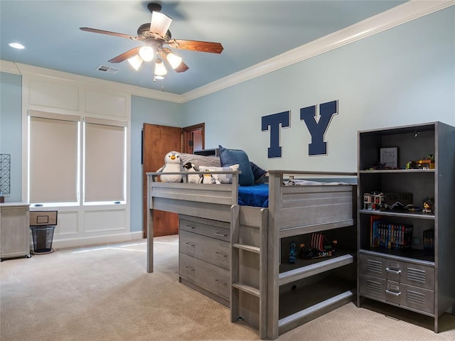 carpeted bedroom with ceiling fan and crown molding