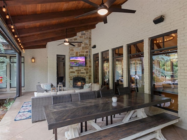 view of patio / terrace featuring an outdoor living space with a fireplace and ceiling fan