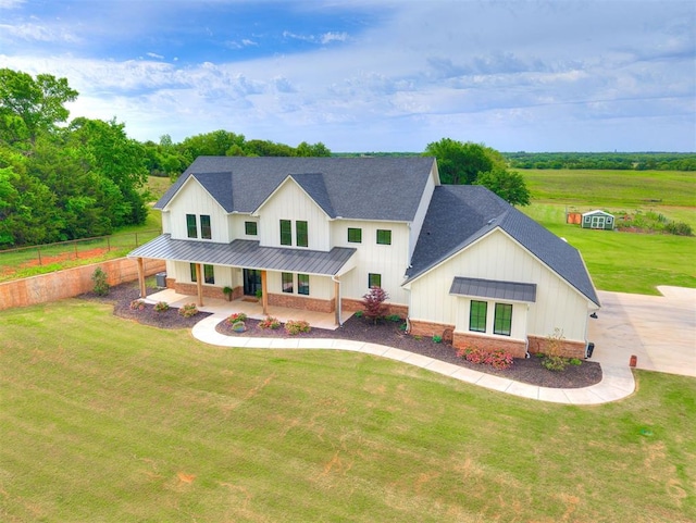 10908 E Danforth Rd, Arcadia, OK 73007 - modern farmhouse style home featuring a standing seam roof, board and batten siding, a shingled roof, a porch, and metal roof