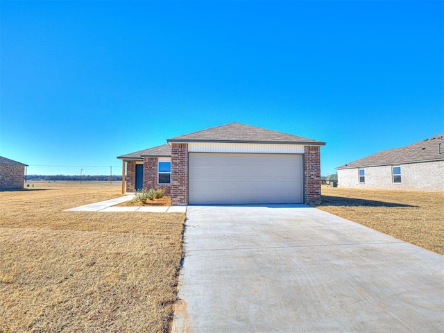 view of front of home featuring a garage and a front lawn