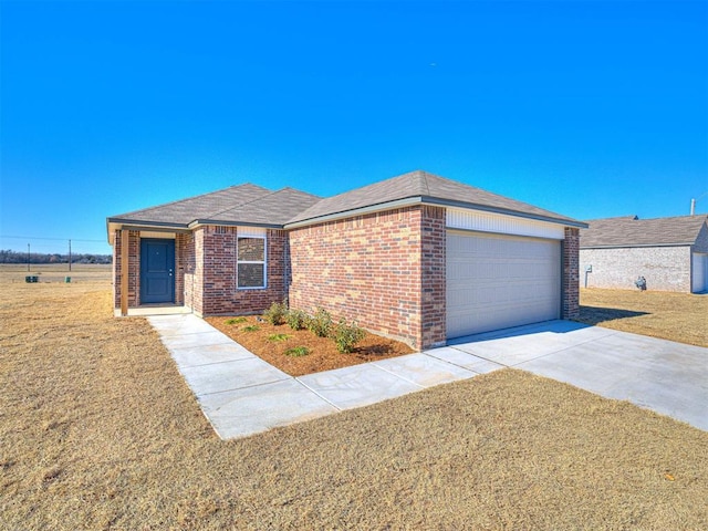 view of front of home with a garage and a front lawn