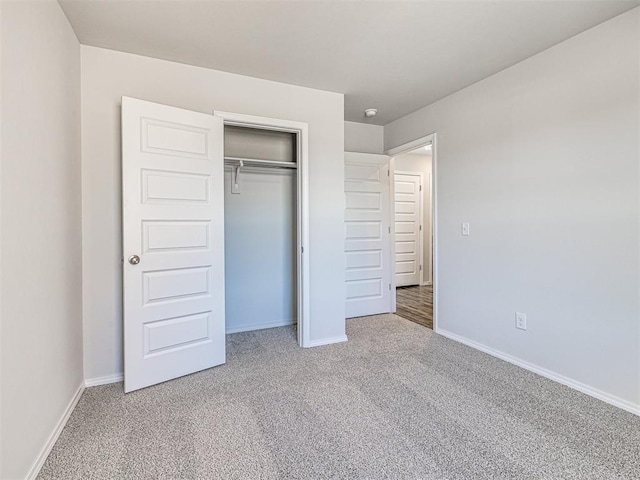 unfurnished bedroom featuring carpet floors and a closet