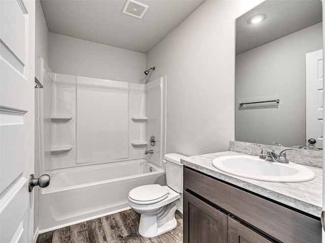 full bathroom with shower / bathtub combination, wood-type flooring, toilet, and vanity