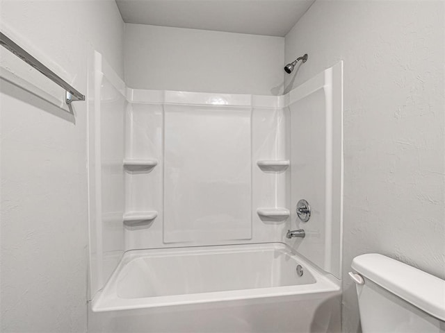 bathroom featuring shower / bathtub combination and toilet