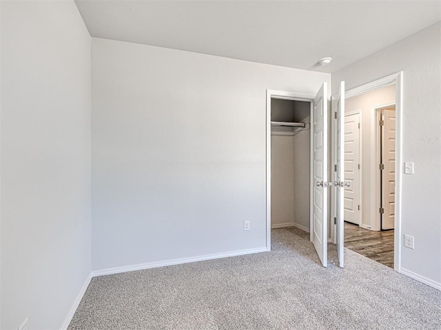 unfurnished bedroom with carpet flooring and a closet