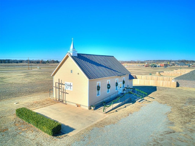 exterior space featuring a rural view and a patio