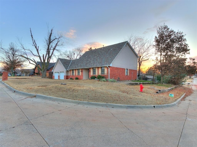 view of front of home with a garage and a yard