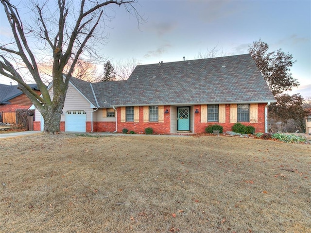 view of front of property featuring a lawn and a garage