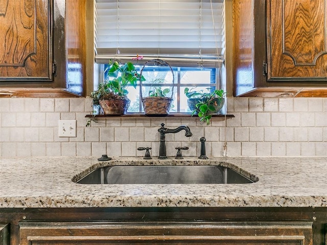 kitchen featuring backsplash and sink