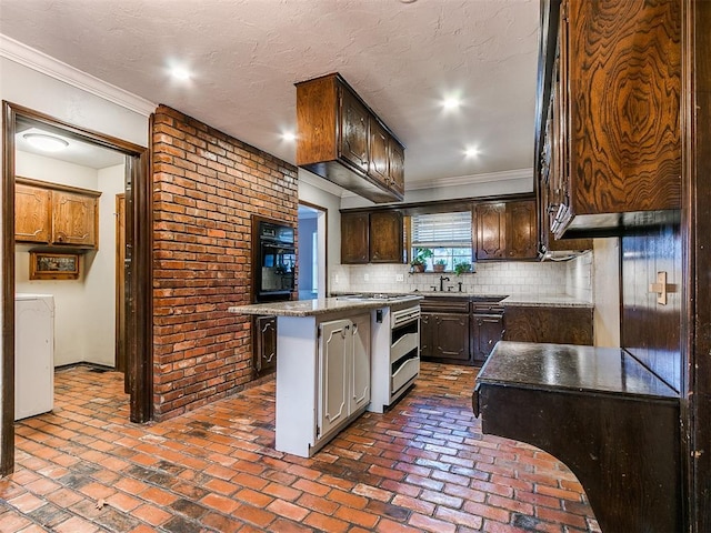 kitchen with a center island, stainless steel gas range, backsplash, a kitchen bar, and ornamental molding