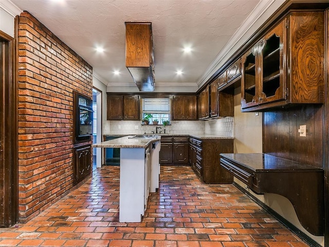 kitchen with a kitchen breakfast bar, tasteful backsplash, dark brown cabinets, stone countertops, and a center island