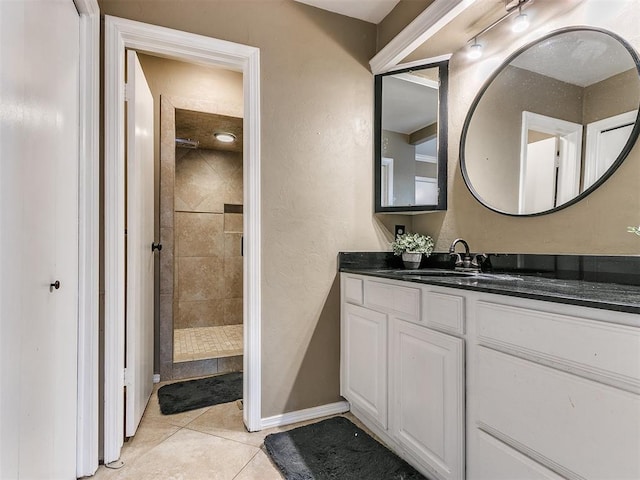 bathroom featuring tile patterned floors, vanity, and tiled shower