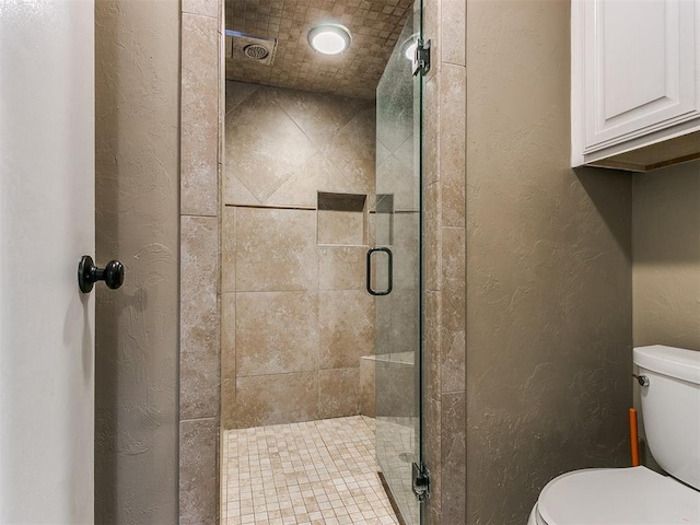 bathroom with toilet and walk in shower