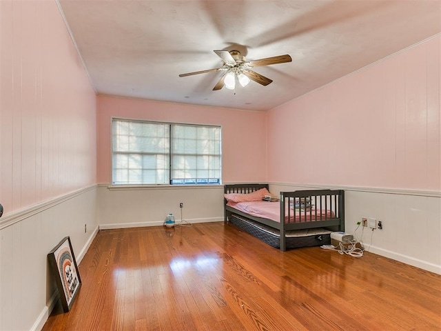 unfurnished bedroom with hardwood / wood-style floors and ceiling fan