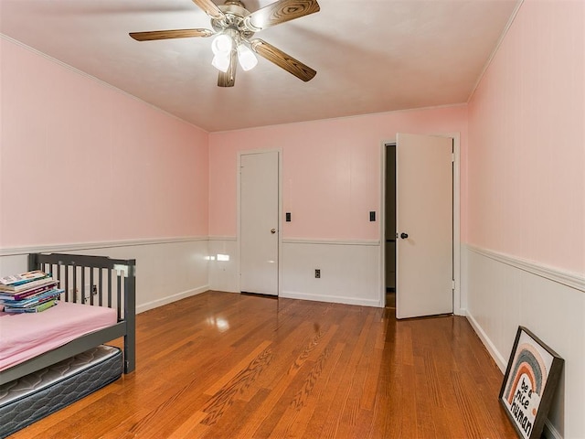 bedroom featuring hardwood / wood-style flooring and ceiling fan