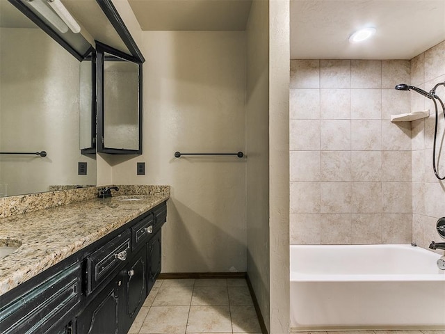 bathroom with tile patterned floors, vanity, and tiled shower / bath combo