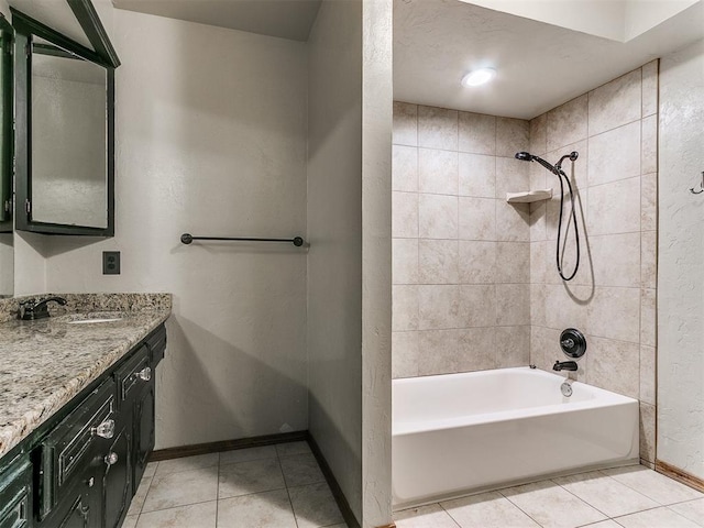 bathroom with tile patterned floors, vanity, and tiled shower / bath combo