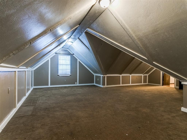 bonus room featuring lofted ceiling and a textured ceiling