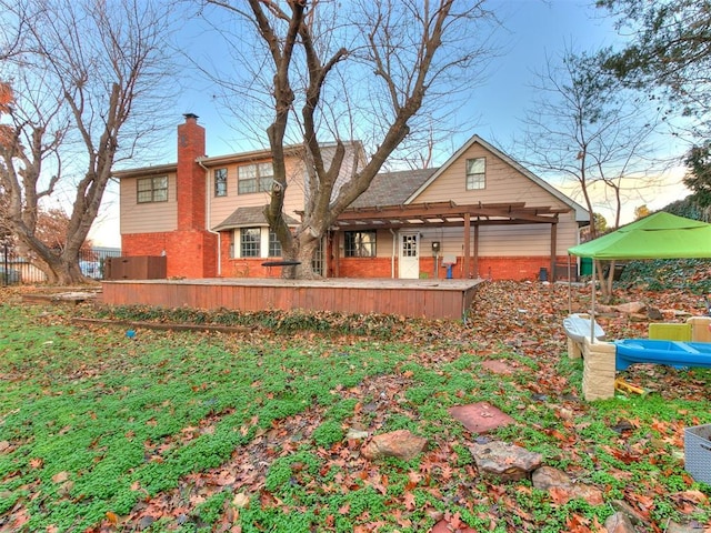 back of property featuring a pergola