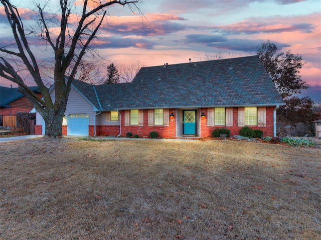 view of front of house featuring a garage, brick siding, and a front yard