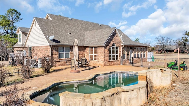 back of house featuring a fenced in pool and a patio area