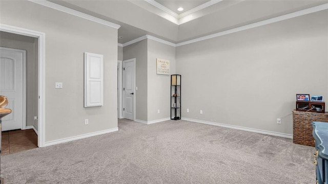 unfurnished bedroom with a raised ceiling, crown molding, and light colored carpet