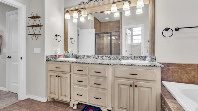 bathroom with plus walk in shower, vanity, and tile patterned floors