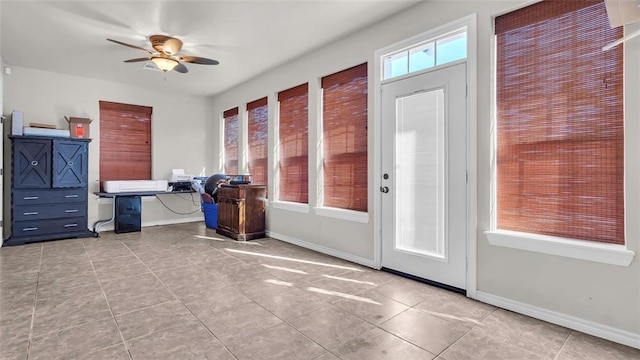 unfurnished office featuring light tile patterned floors and ceiling fan