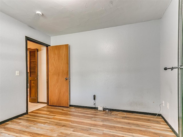 unfurnished room with light hardwood / wood-style floors