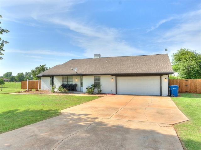 ranch-style house featuring a front yard and a garage