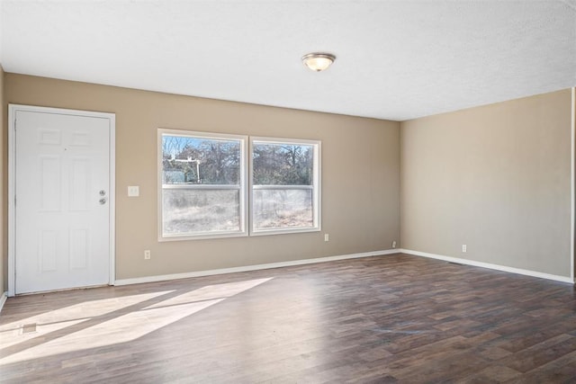 empty room with dark hardwood / wood-style floors