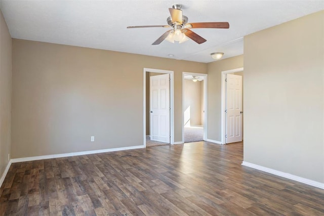 empty room featuring dark hardwood / wood-style flooring and ceiling fan