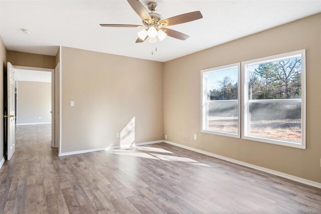 spare room featuring hardwood / wood-style floors and ceiling fan