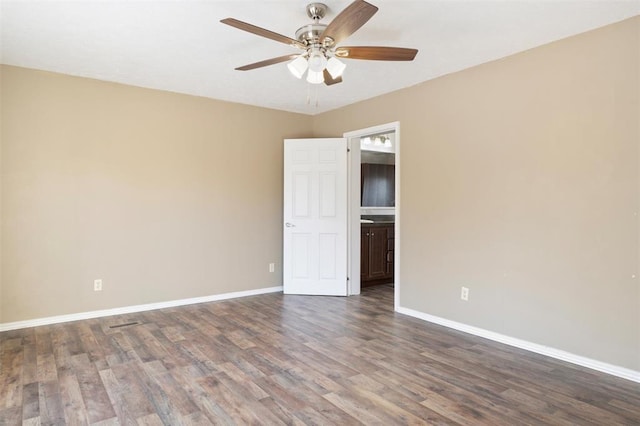 spare room featuring ceiling fan and dark hardwood / wood-style flooring