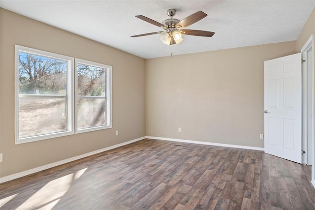 empty room with dark hardwood / wood-style floors and ceiling fan