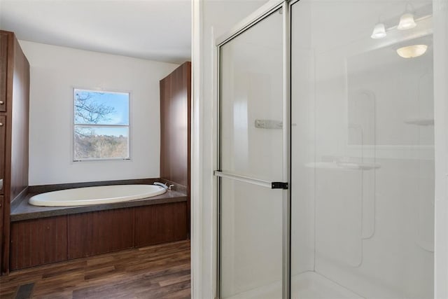 bathroom with wood-type flooring and plus walk in shower