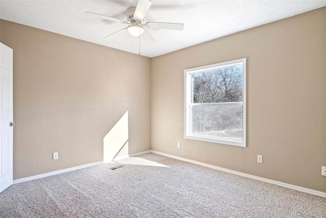 empty room featuring light carpet and ceiling fan